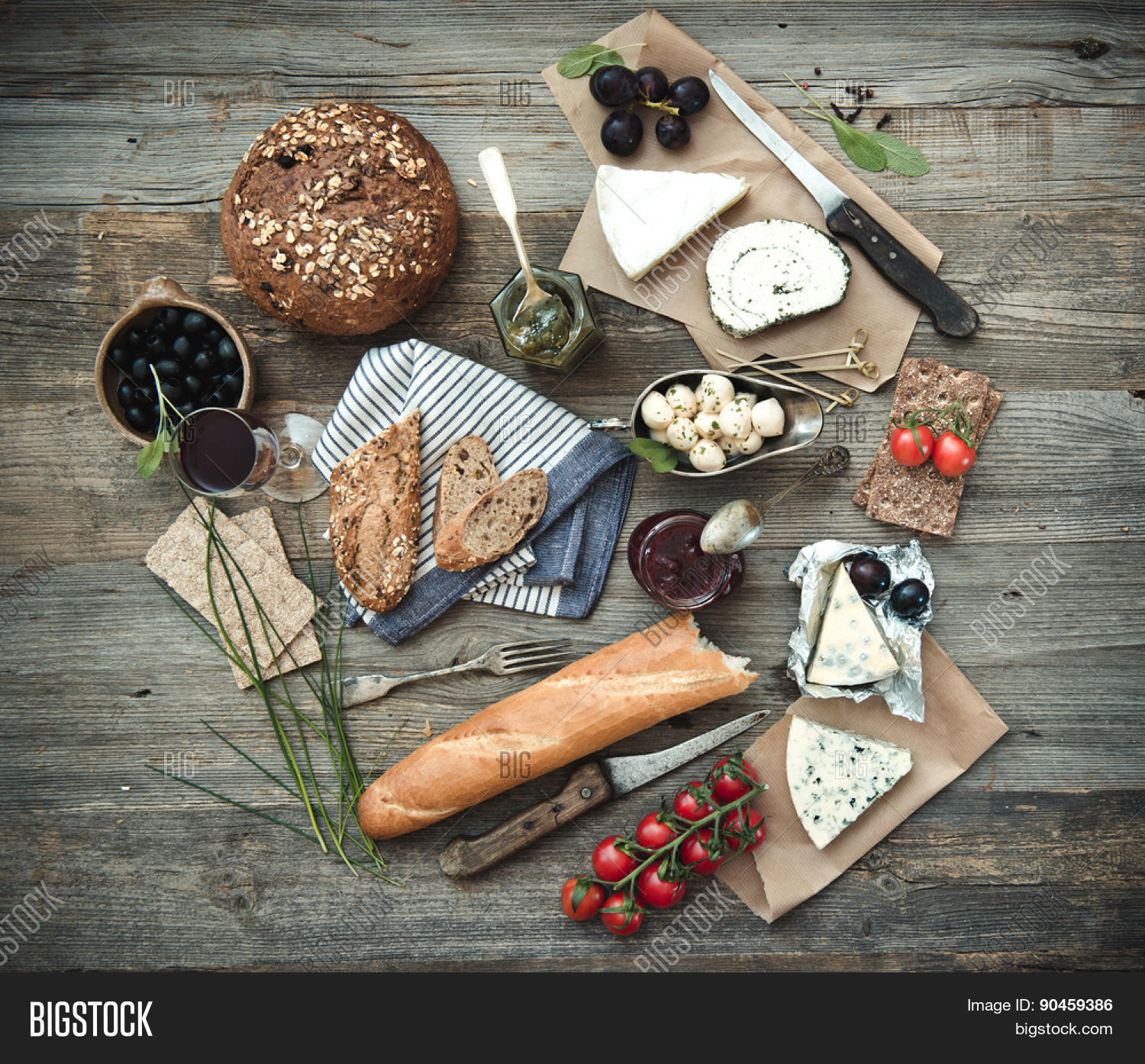 different types of cheese, wine and other ingredients on a