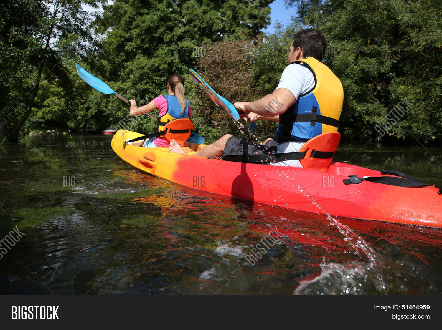 couple riding canoe in river