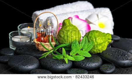 aromatic spa setting of bergamot fruits, fresh mint, rosemary