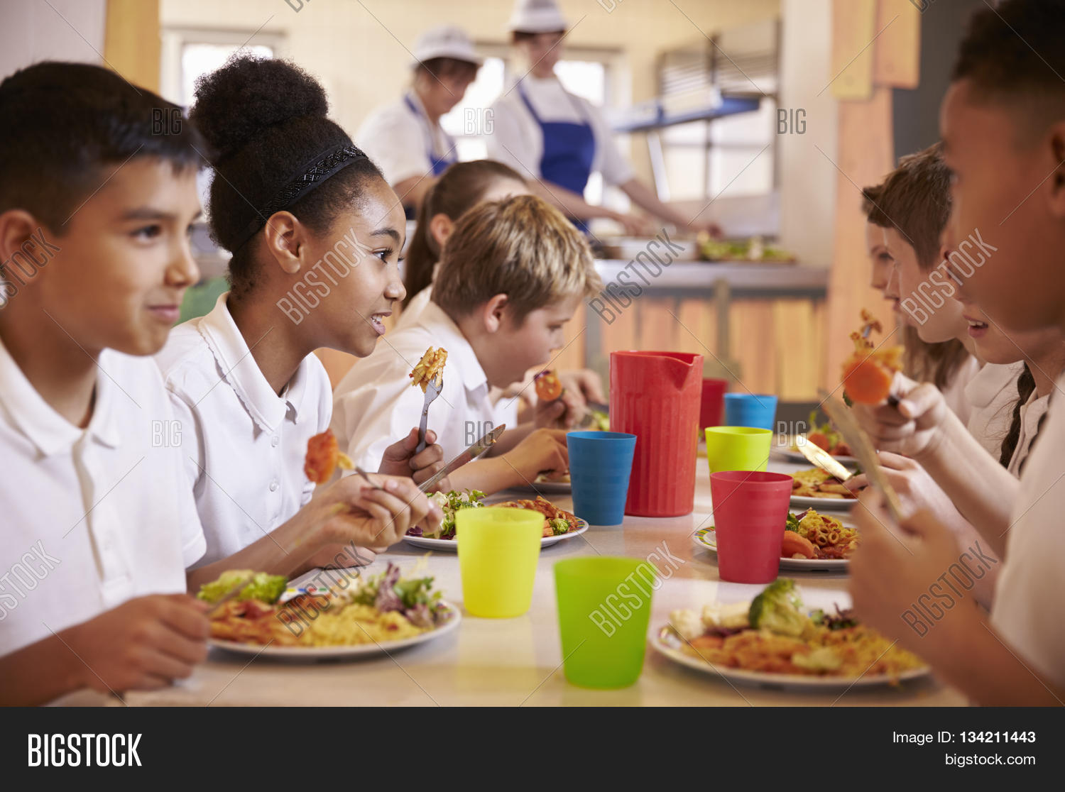 primary school kids eat lunch in school cafeteria, close up