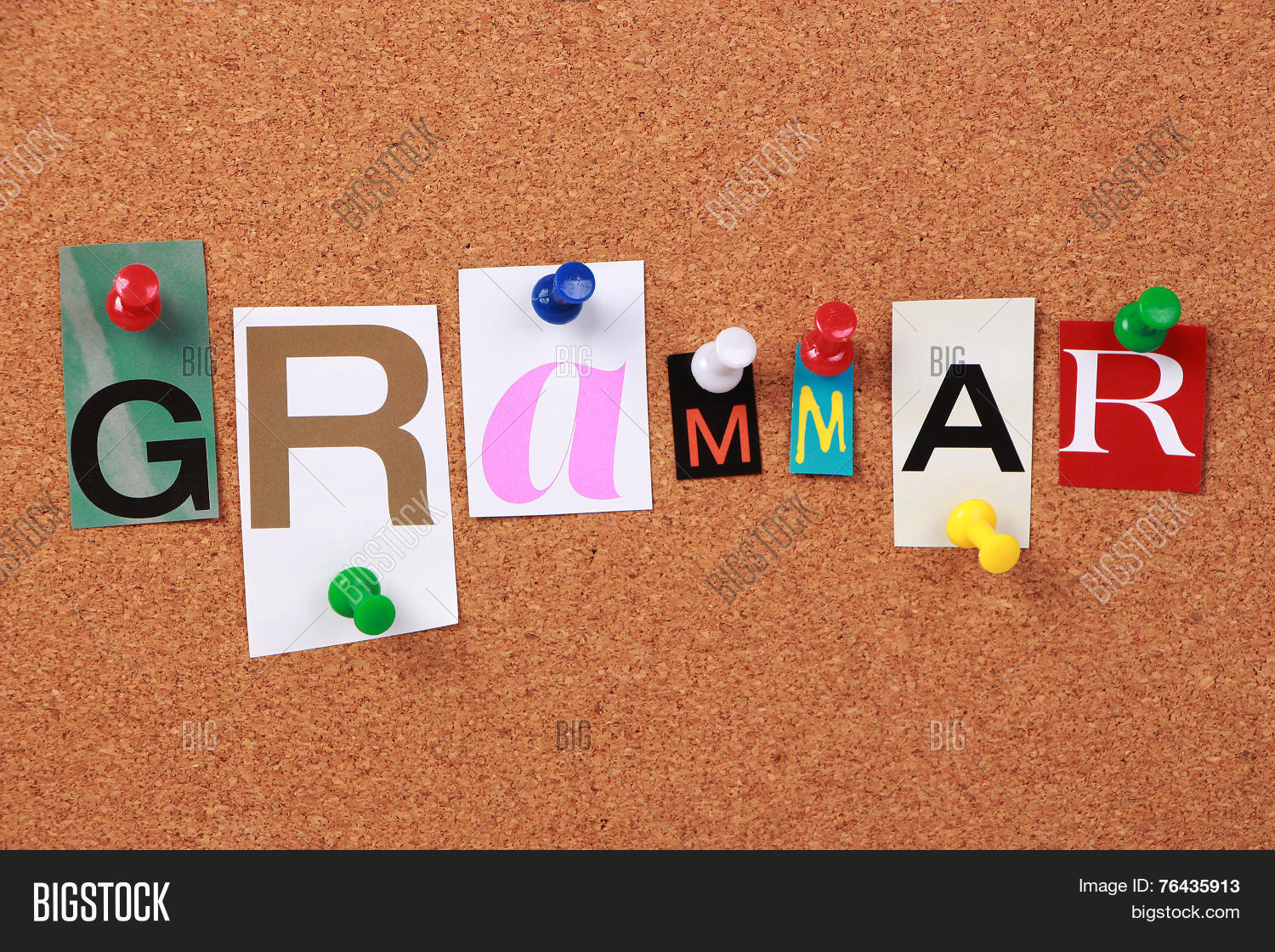 the word grammar in cut out magazine letters pinned to a cork