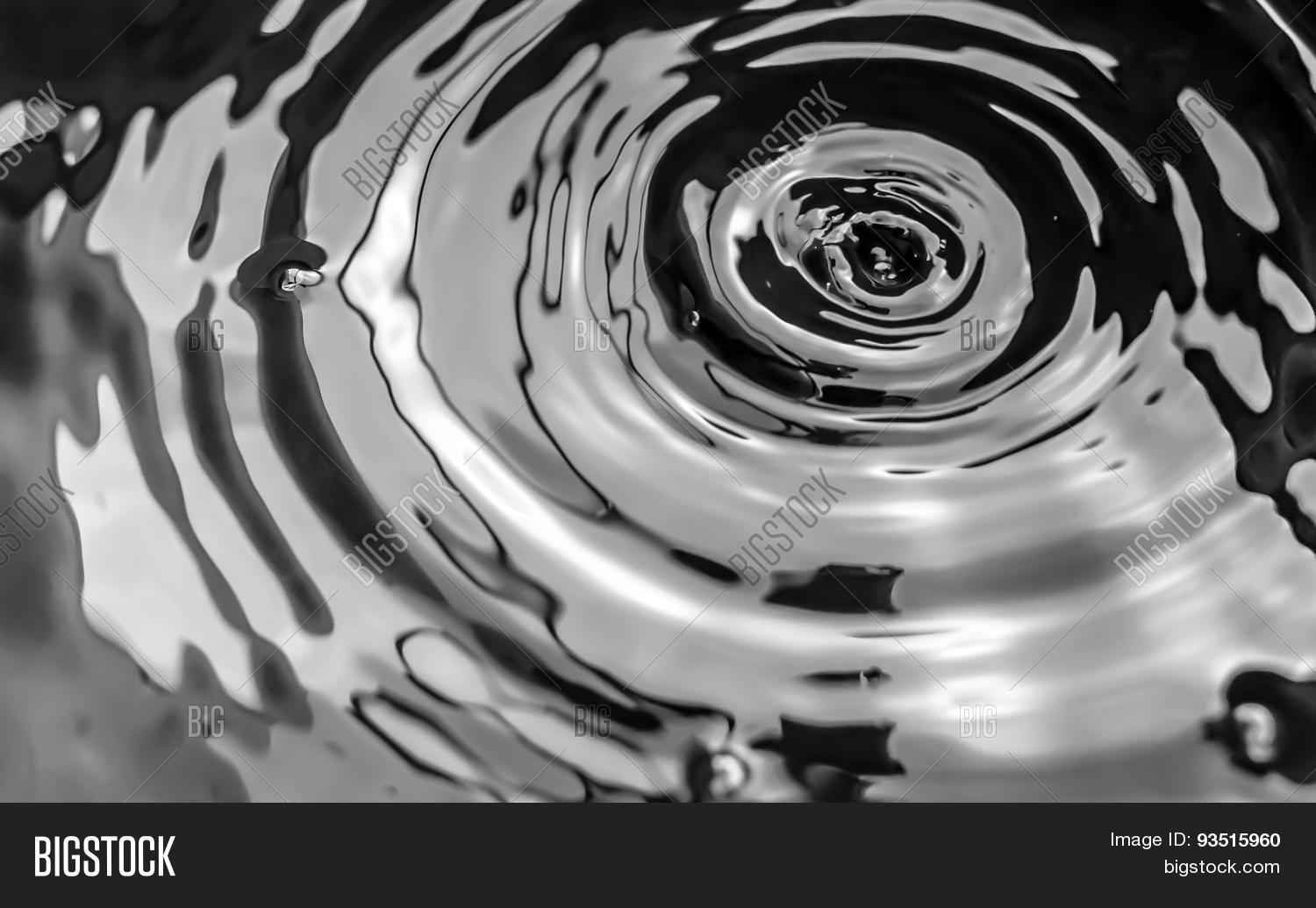 water drops from a leaking pipe causing ripples on water surface