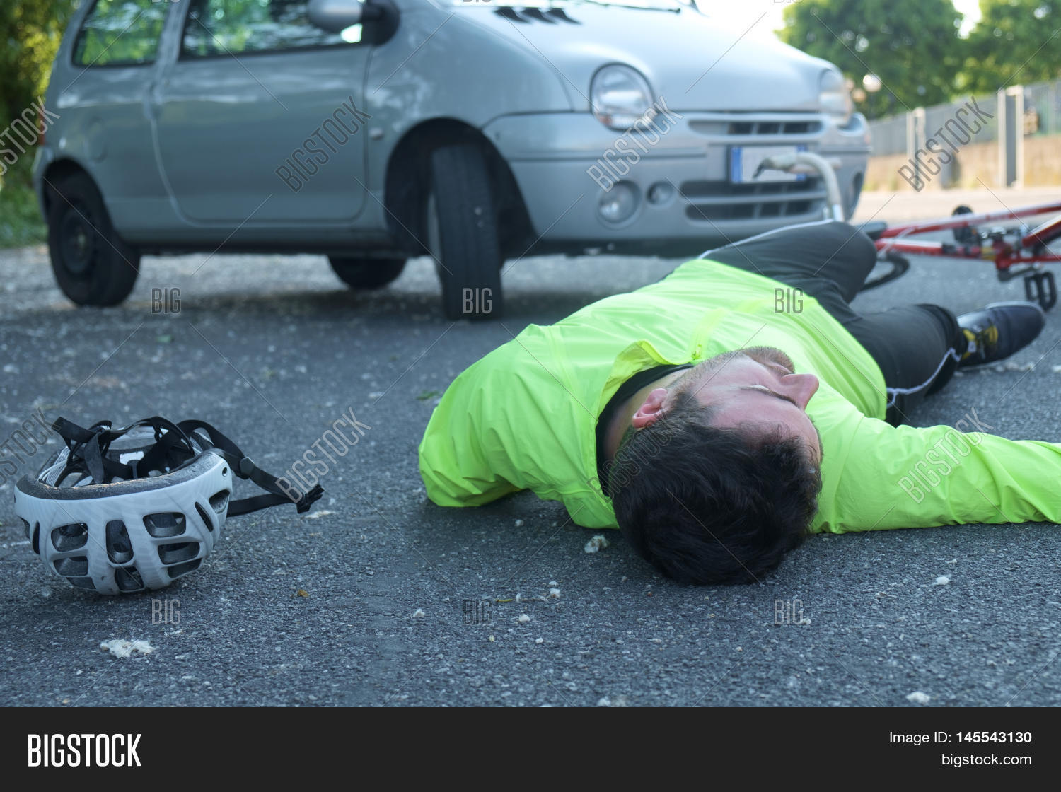 fainted aching man after bicycle accident on the asphalt