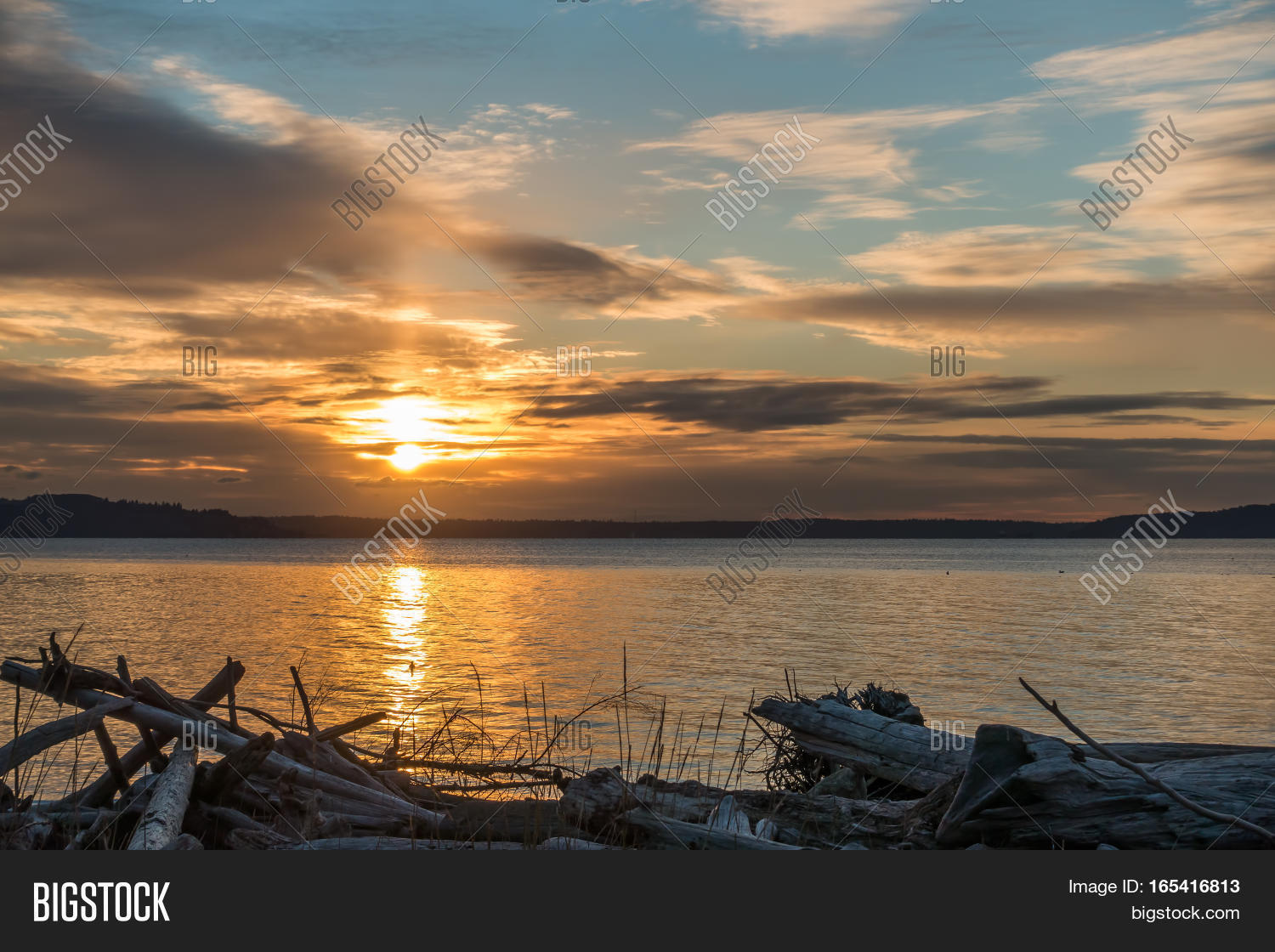 the sun sets over the puget sound in the pacific northwest.