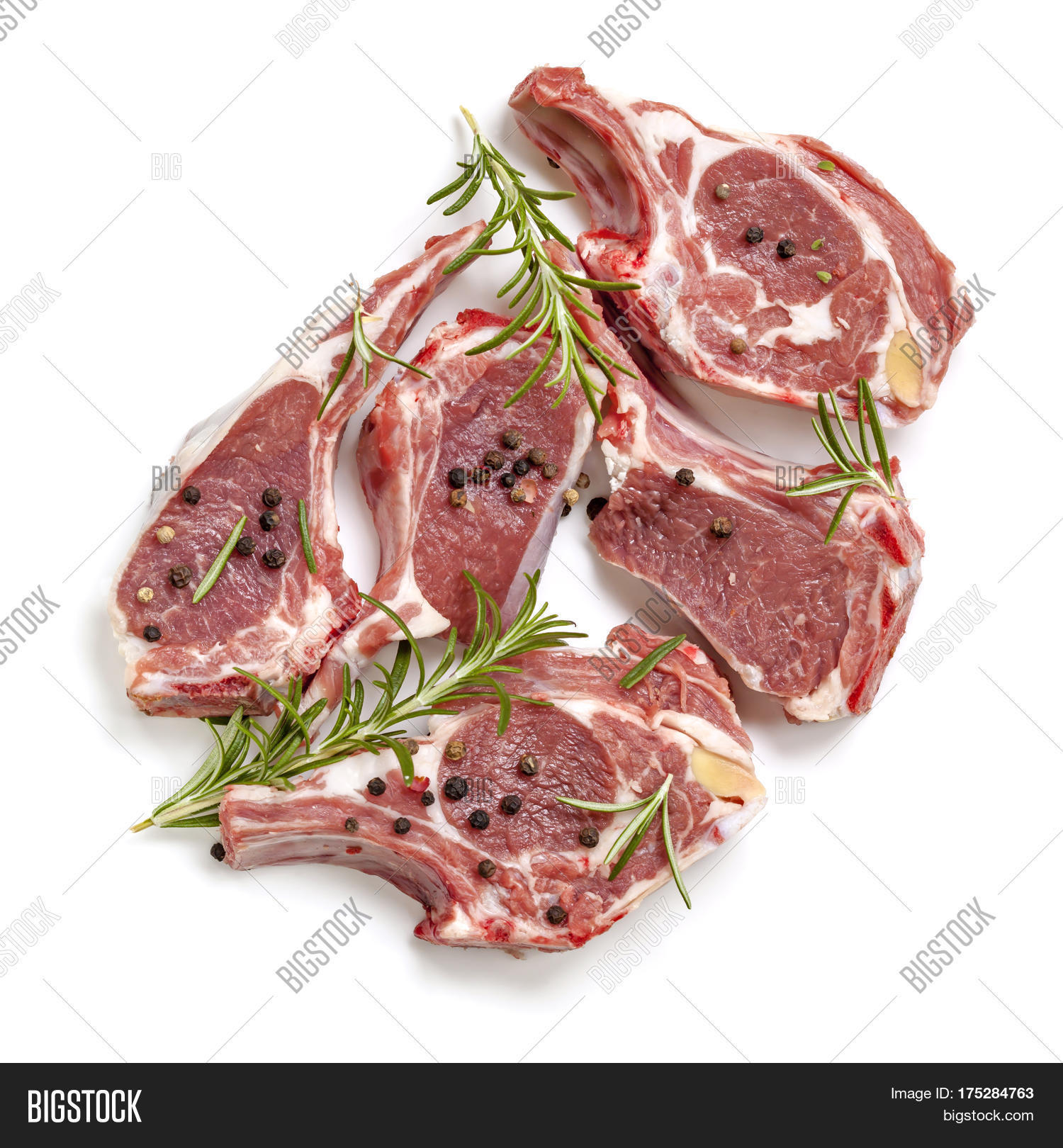 raw lamb cutlets, top view, isolated, with rosemary and pepper