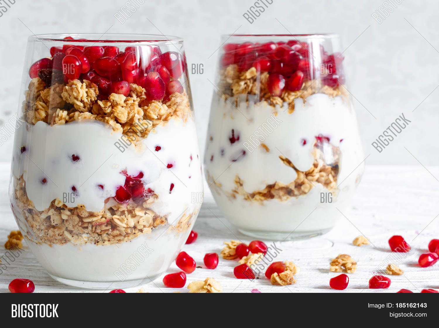 homemade yogurt parfait with granola and pomegranate fruit in