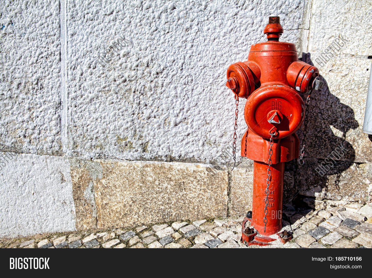 a closeup red fire hydrant on a street