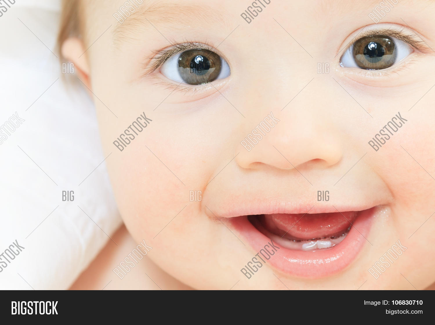 a baby boy playing on the parent bed