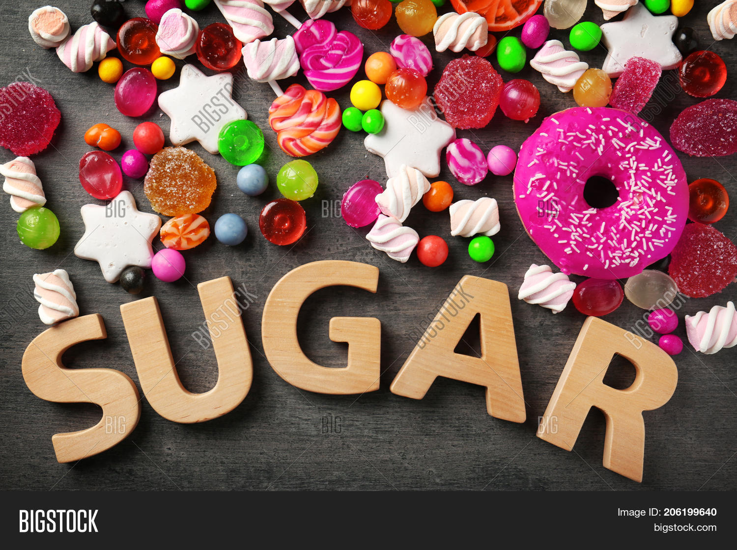 sugar composition with variety of sweets on grey background