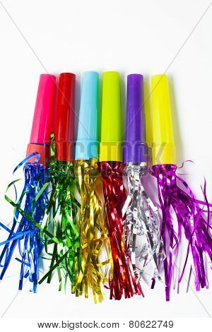 party horn blower with colored streamers on white background