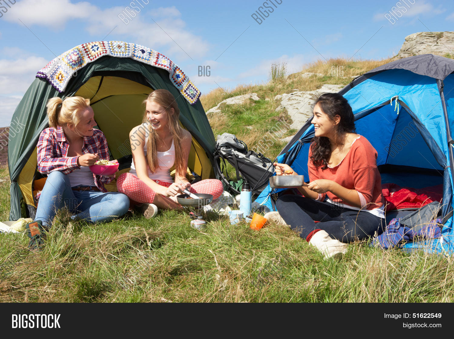 group of teenage girls on camping trip in countryside