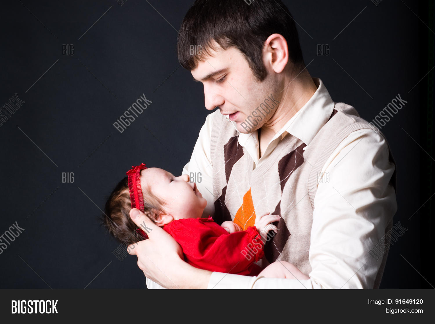 father holding his baby daughter with tenderness isolated on