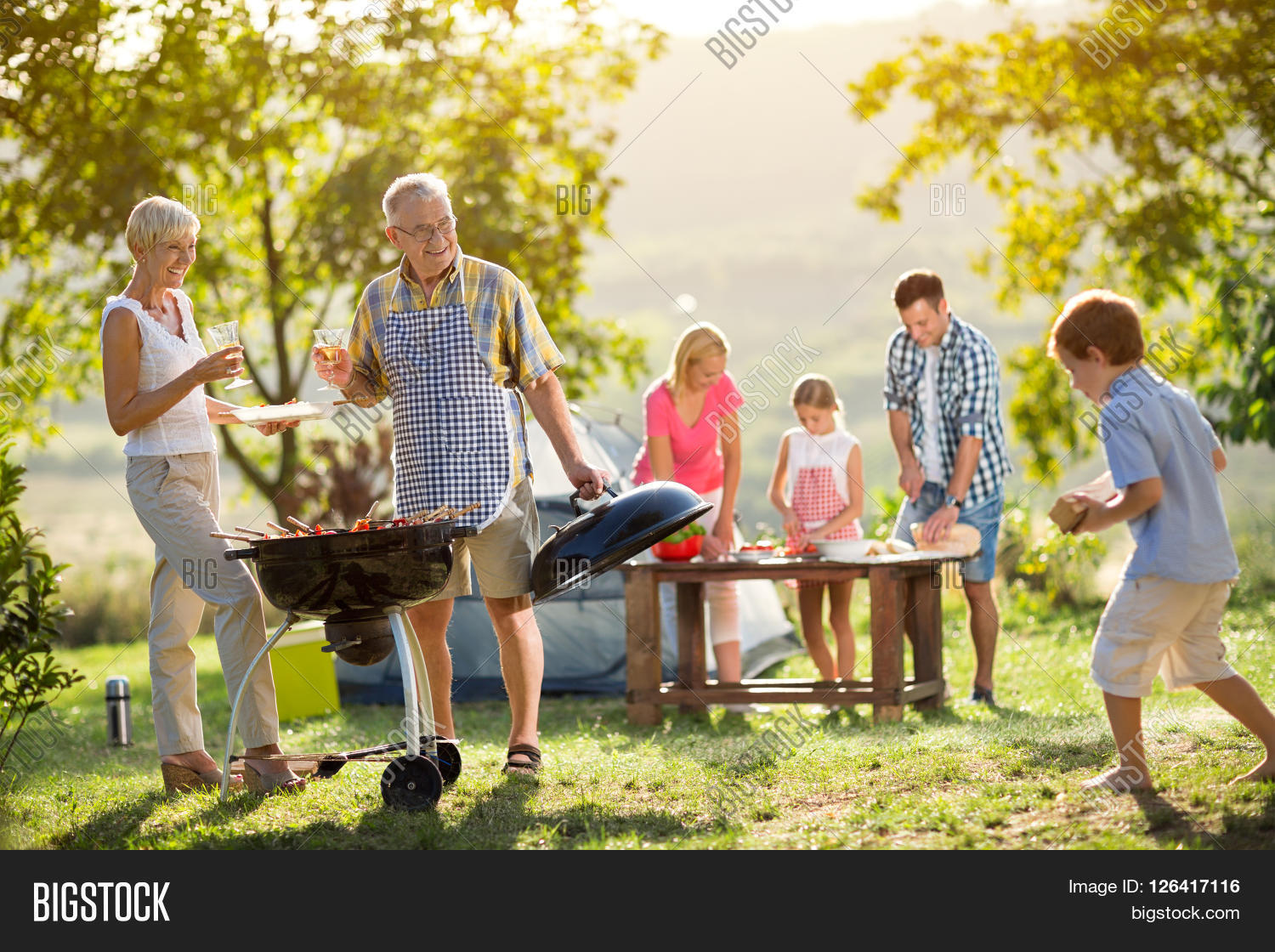happy family camping and cooking bbq