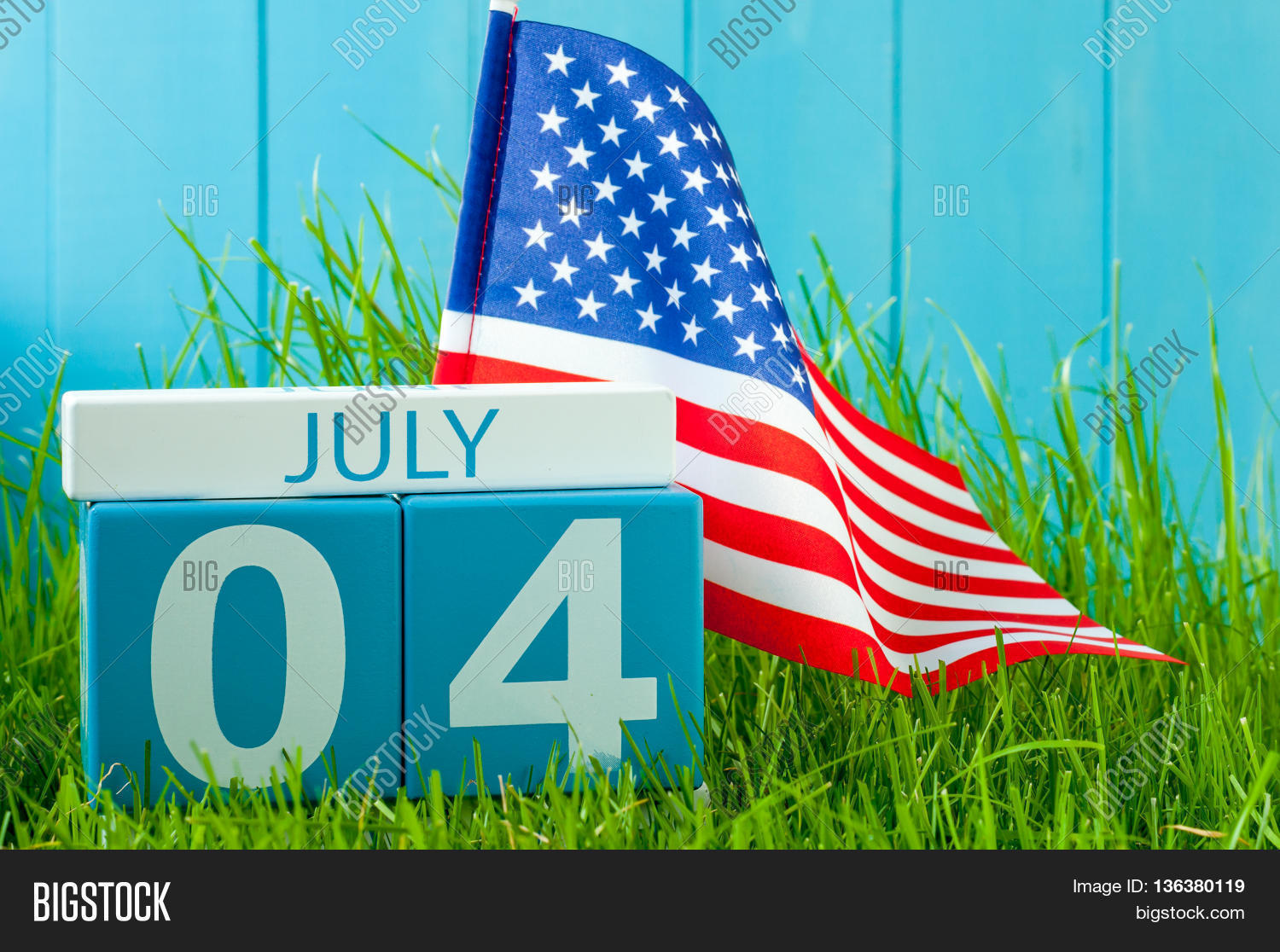 image of july 4 wooden color calendar on blue background with