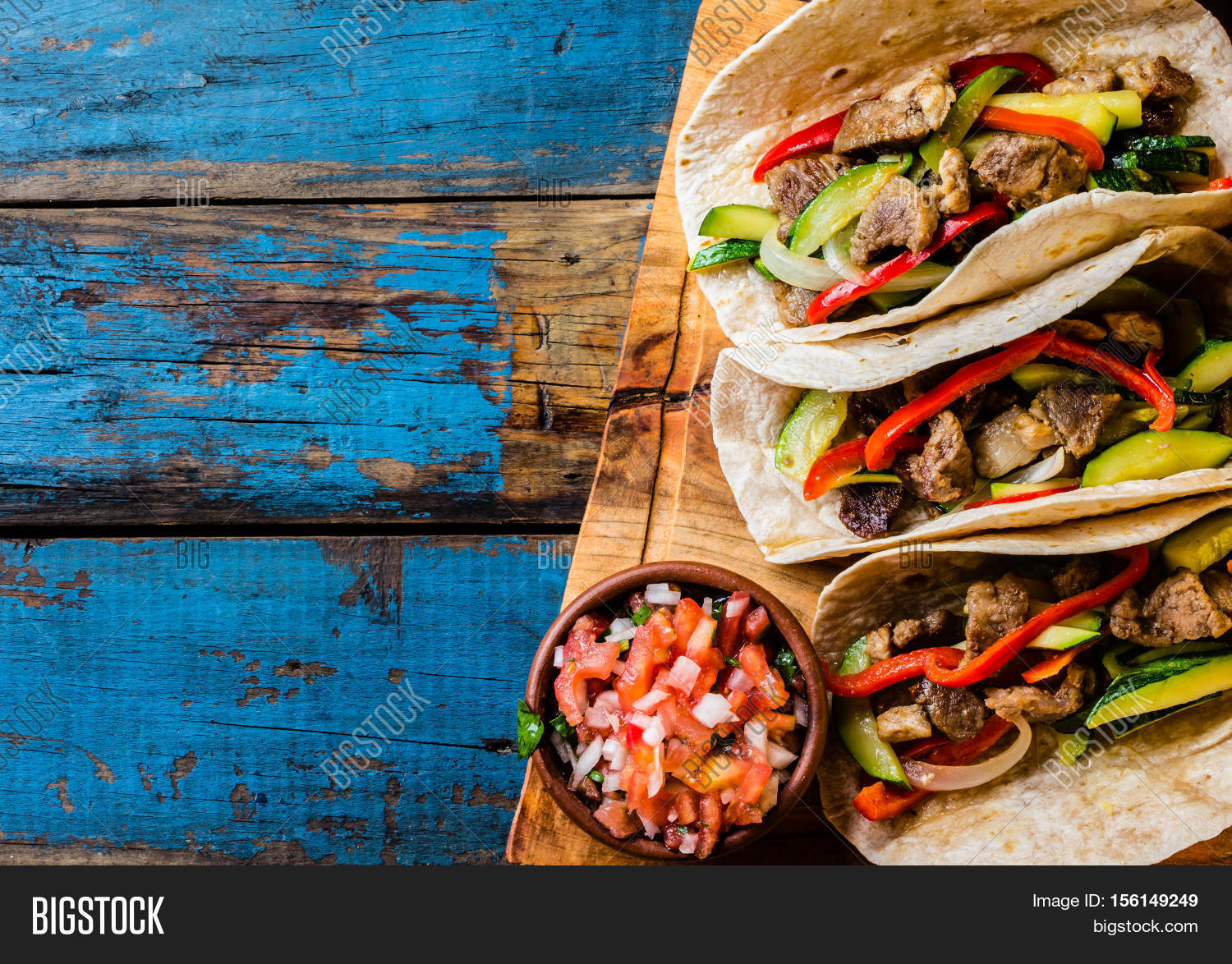 mexican pork tacos with vegetables and salsa.