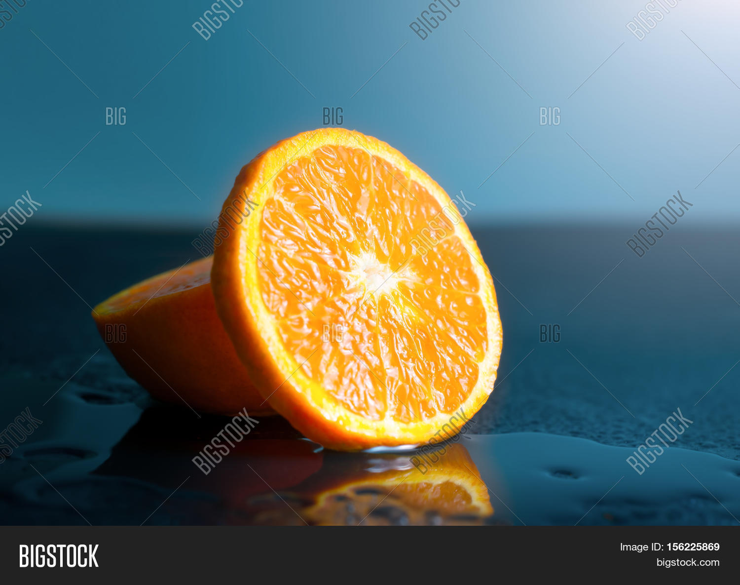 still life orange slice fruit on dark background.