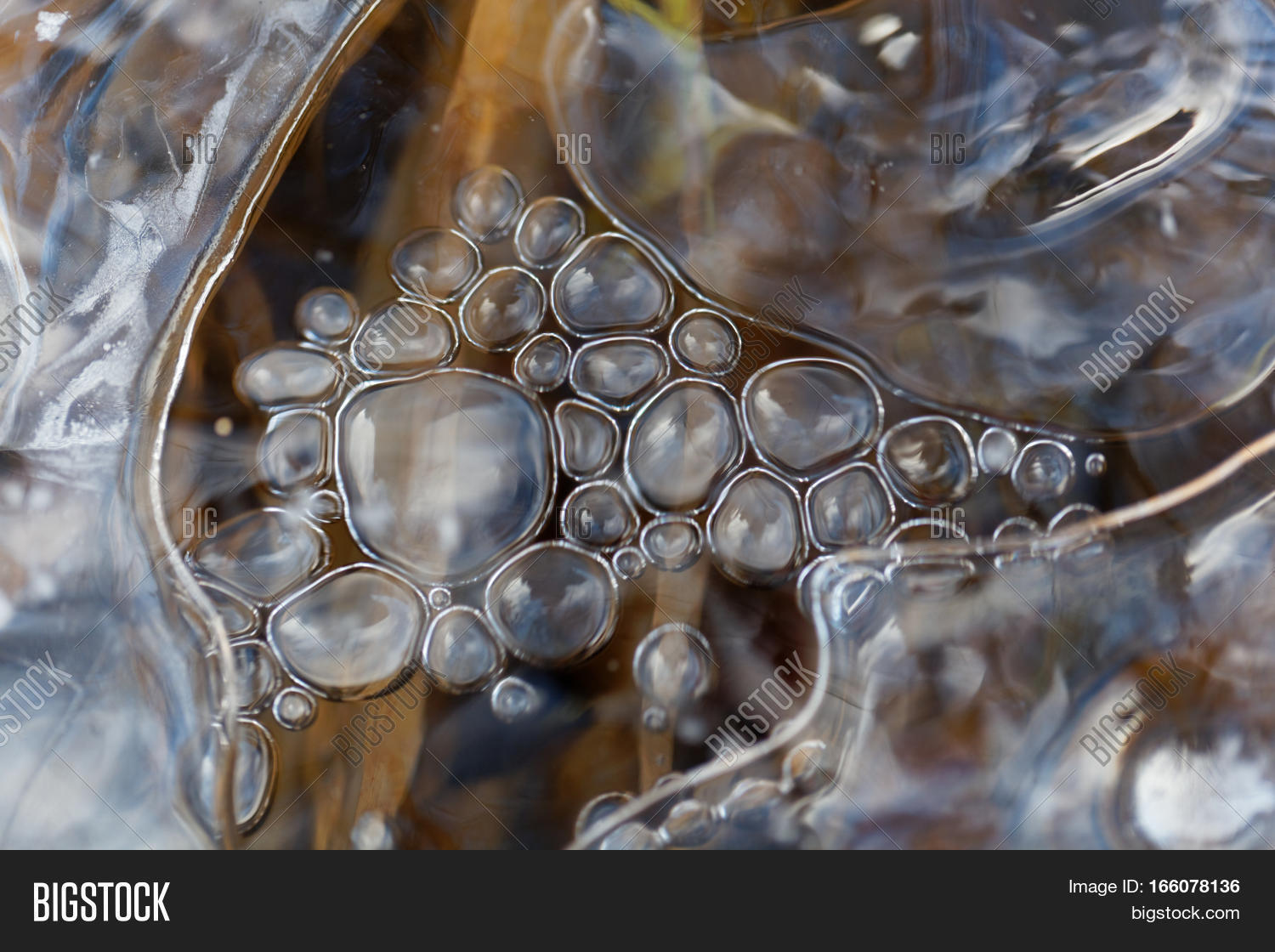 ice on a lake surface with air bubbles.