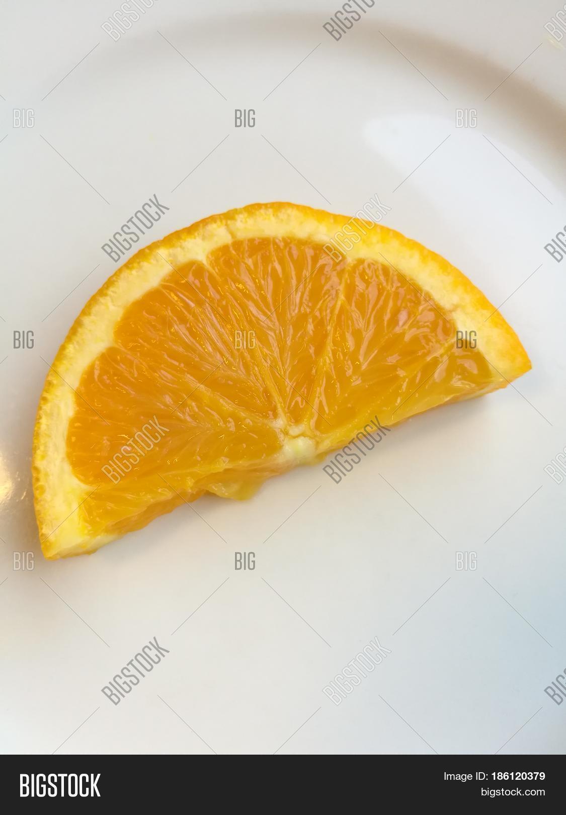 orange slice isolated on white plate pieces of fresh sliced