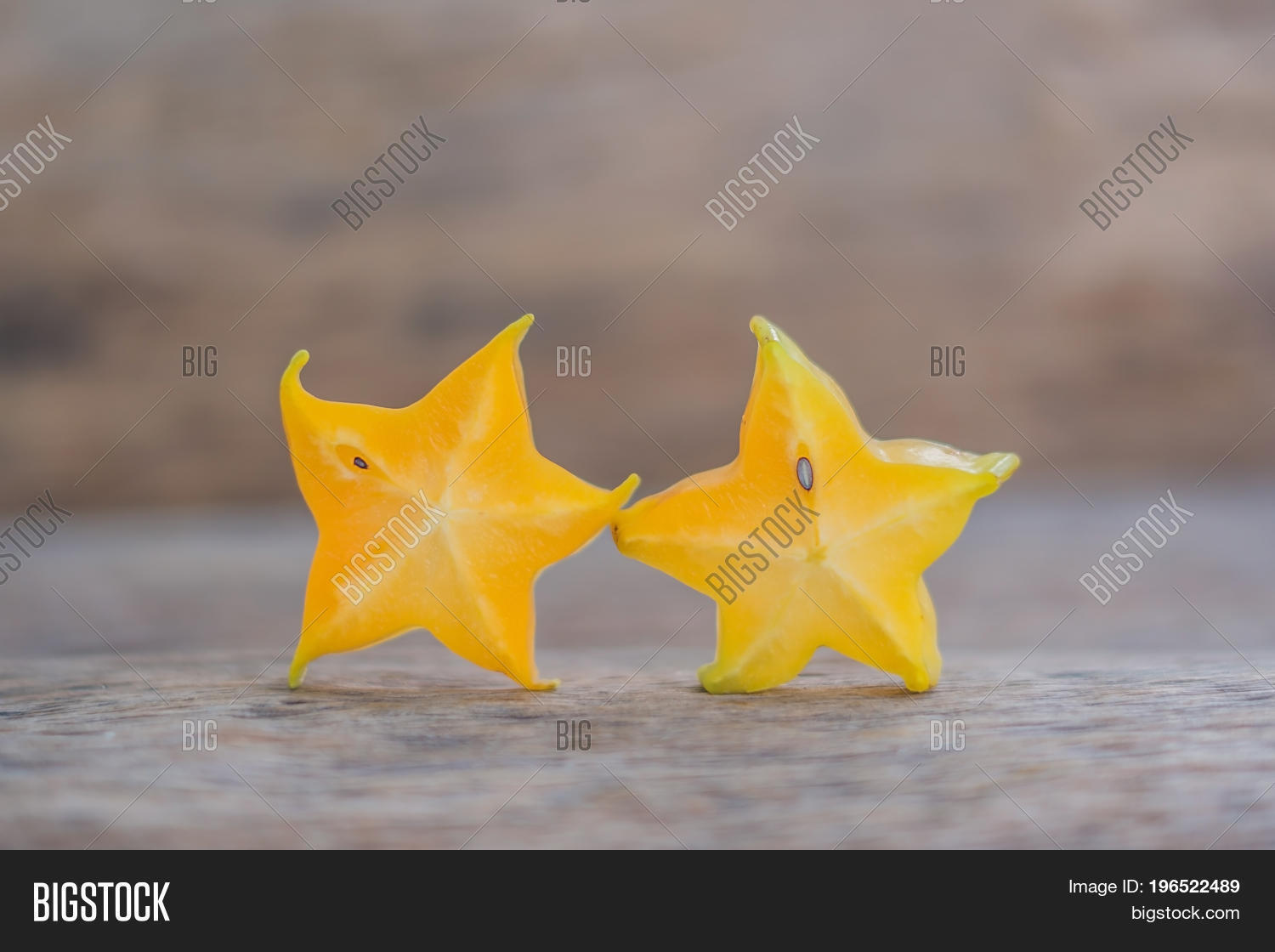 star fruits sliced on wood background. selective focus.