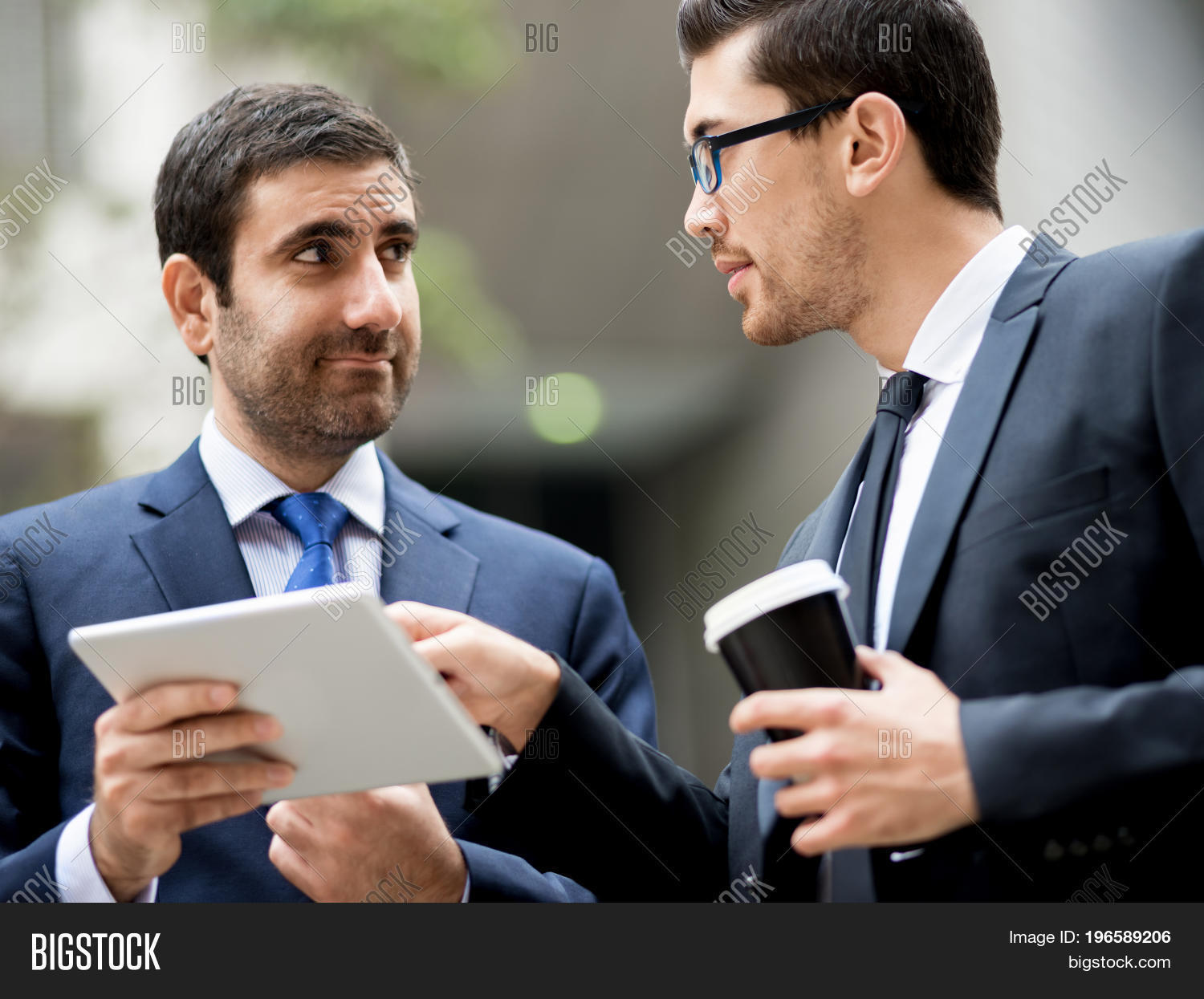 two businessmen talking outdoors