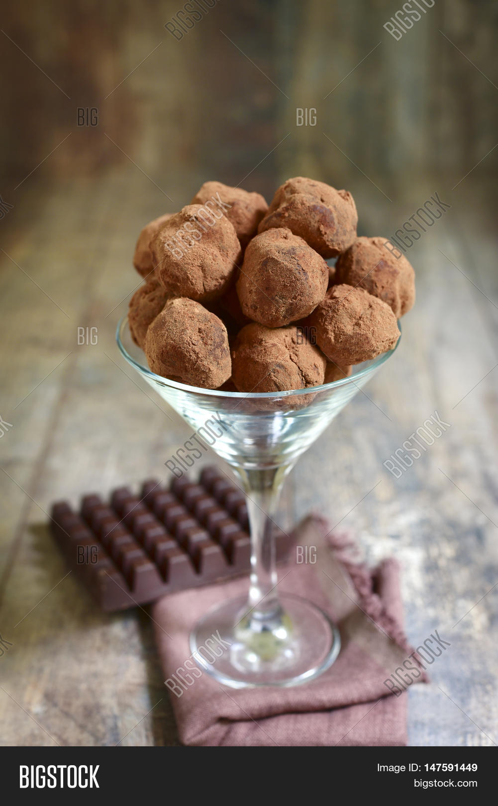 homemade chocolate truffles in a glass on a rustic background.