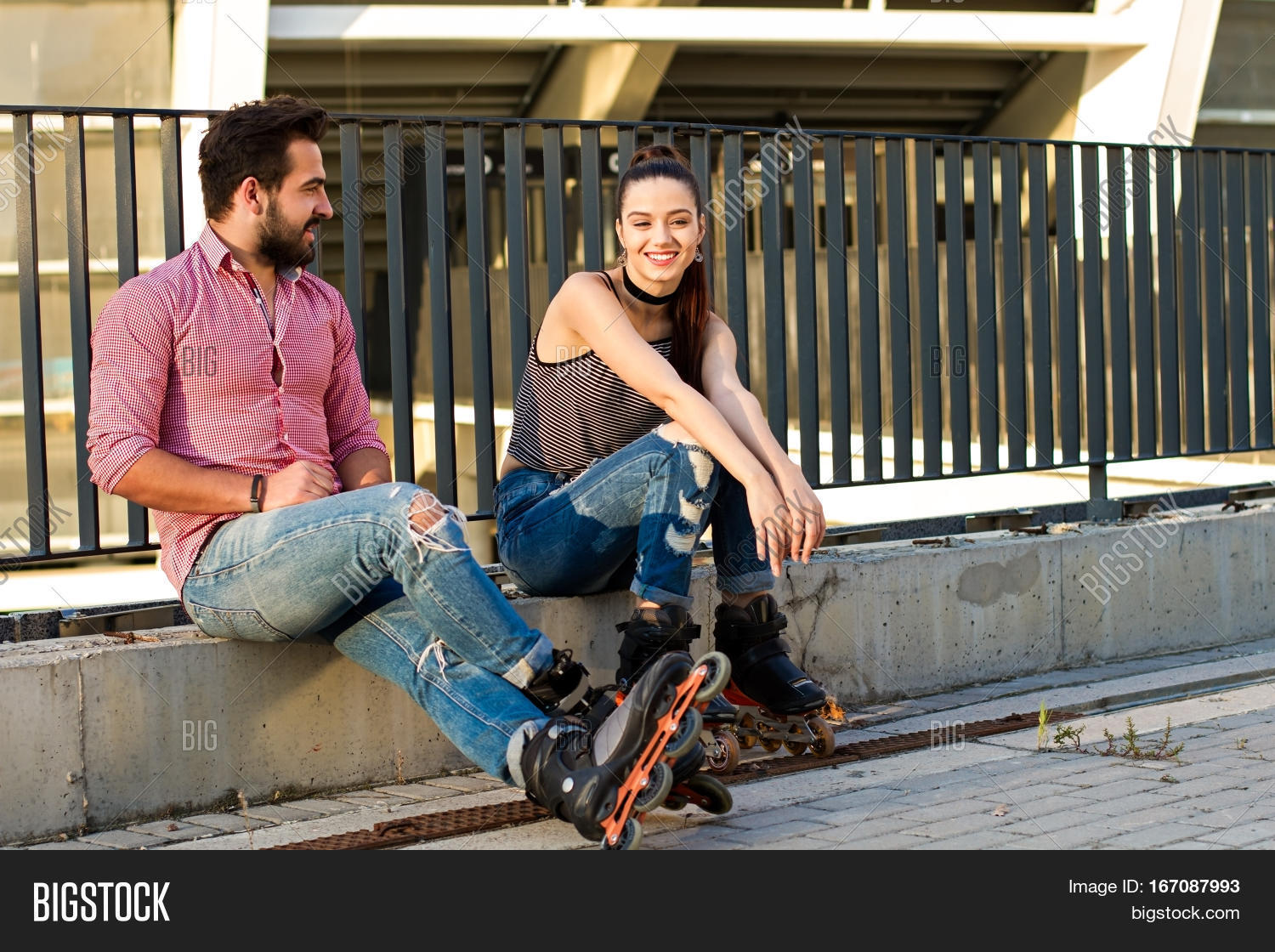 people on inline skates sitting. young woman is smiling.