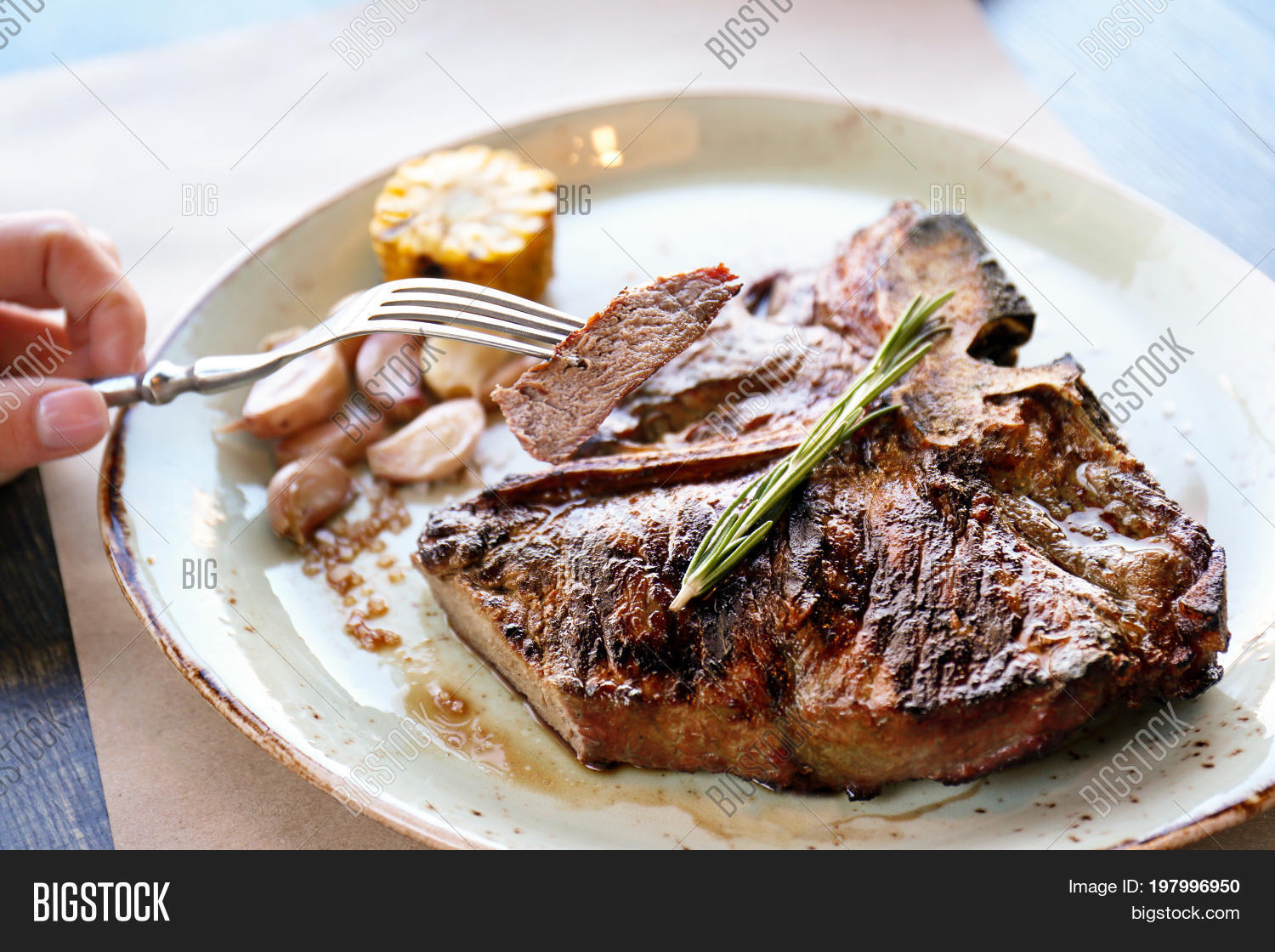 slice of beefsteak on fork over plate