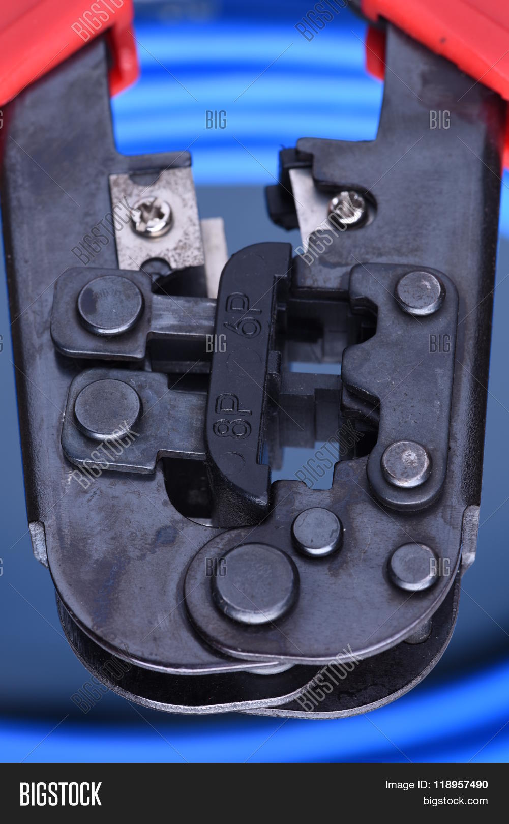 crimping tool with cable for computer network on blue metal