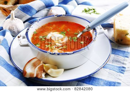 ukrainian beetroot soup - borscht, on blue napkin, on wooden