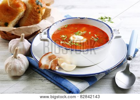 ukrainian beetroot soup - borscht, on blue napkin, on wooden