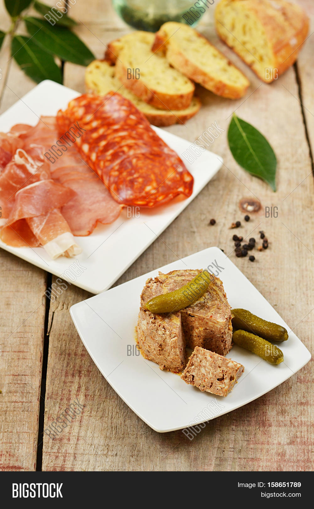 pork liver paste pté with pickles and tapas on wooden back