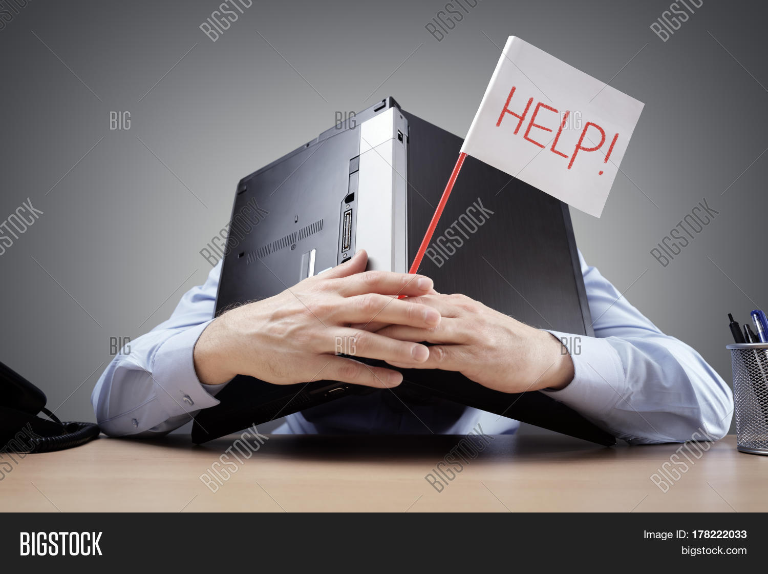 frustrated and overworked businessman burying his head under a
