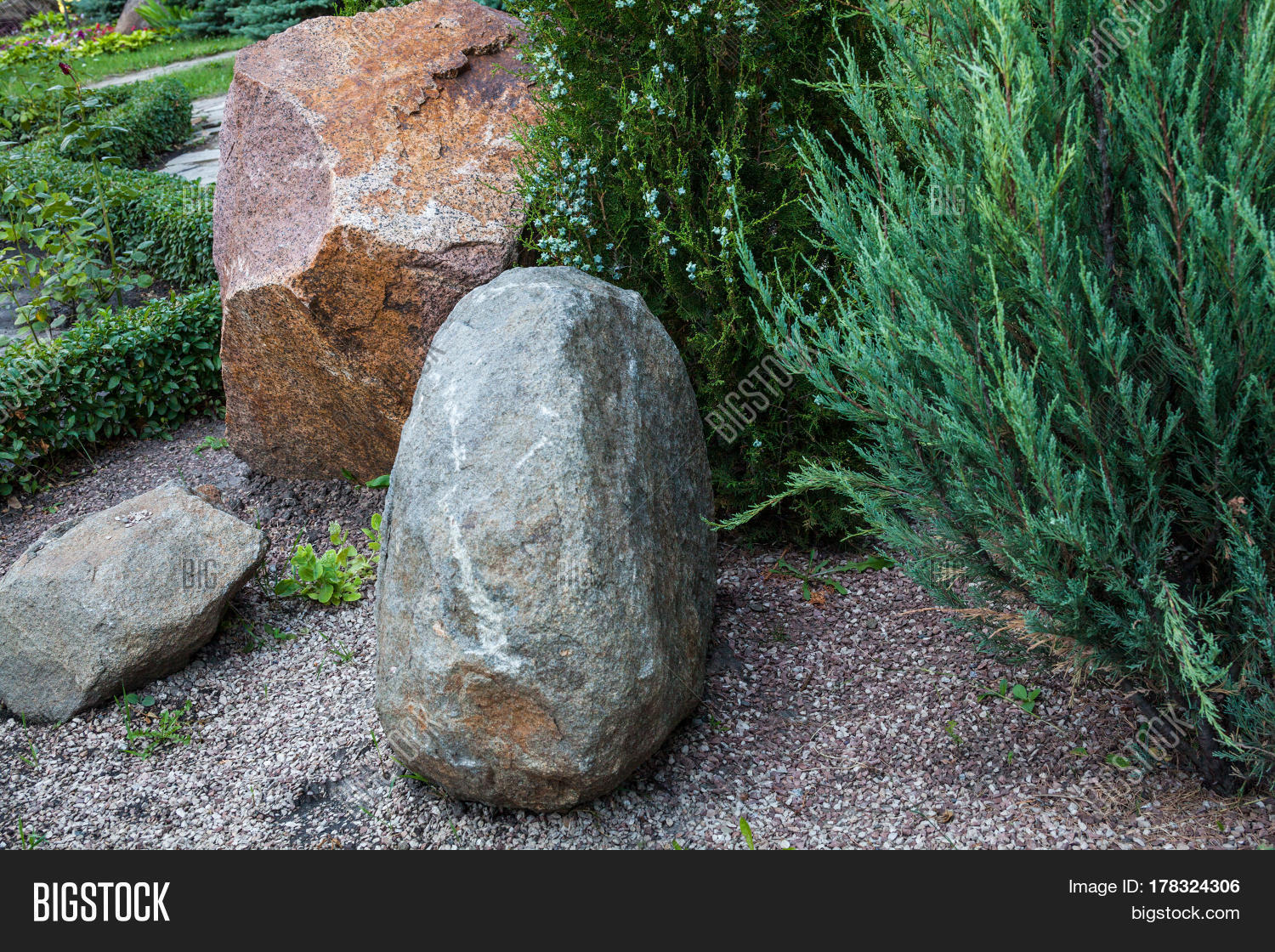 rockery with big stones and different evergreen plants (oriental