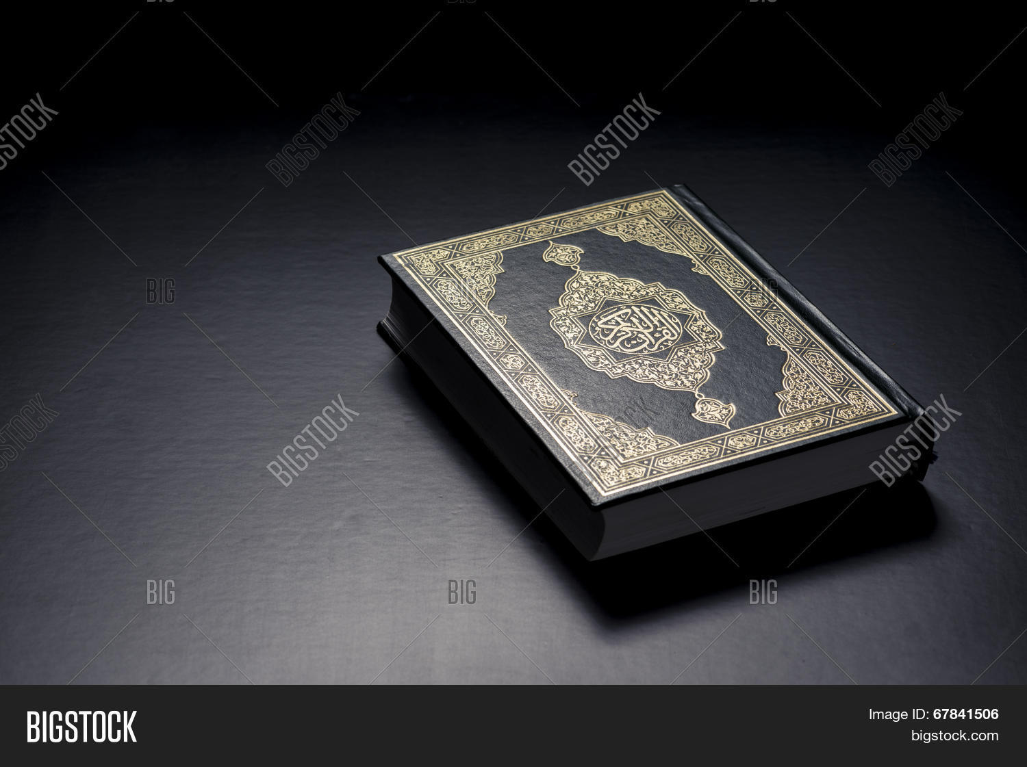 islamic holy book quran under soft light on black background