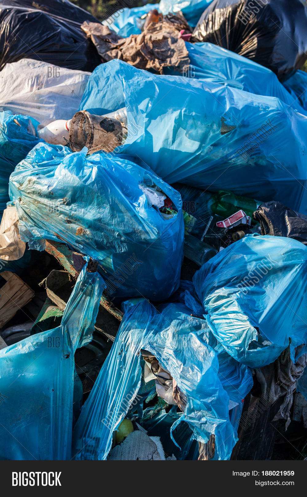 piles of garbage in plastic bin (trash waste) bags. landfill.