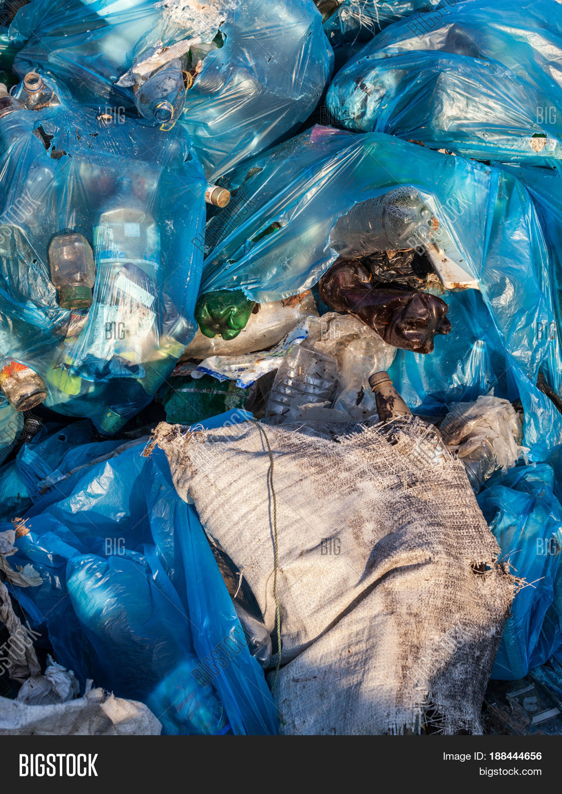 piles of garbage in plastic bin (trash waste) bags. landfill.