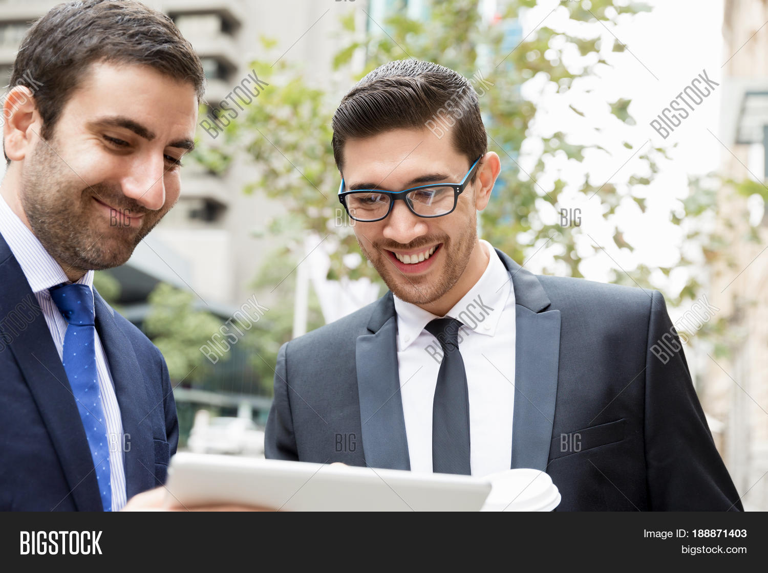 two businessmen talking outdoors