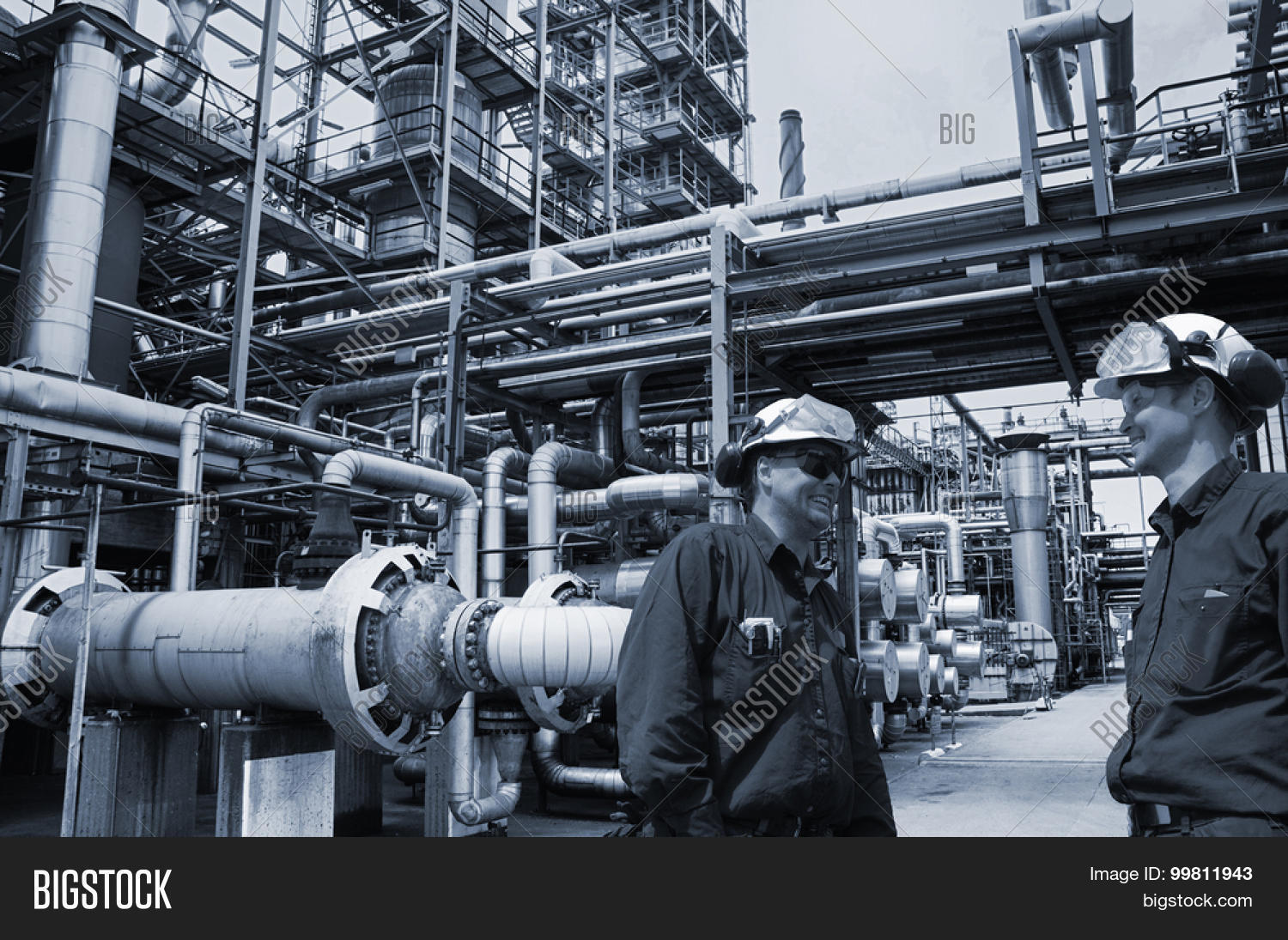 oil and gas engineers inside large petrochemical refinery, blue