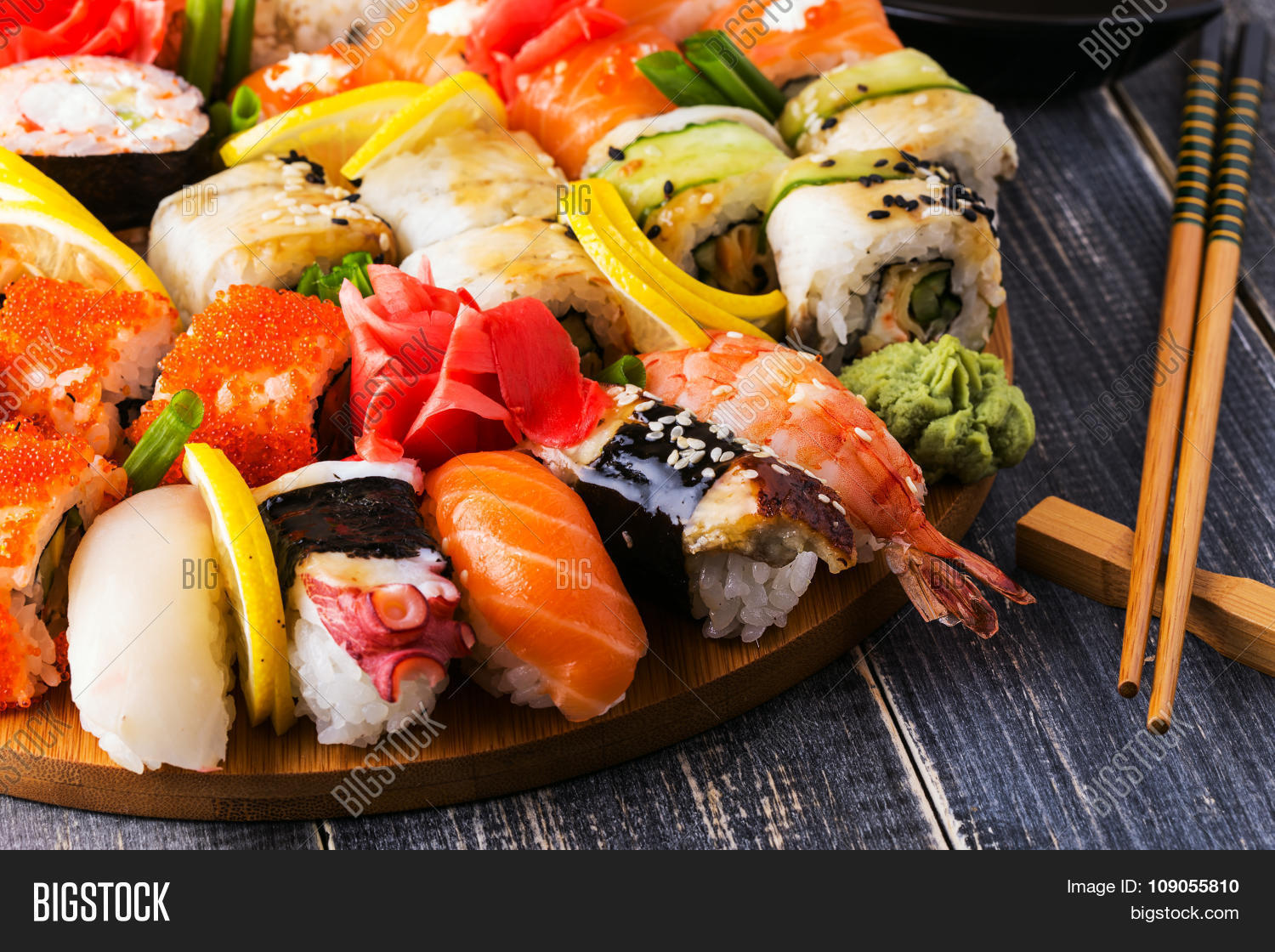 sushi set: sushi and sushi rolls on wooden plate selective focus