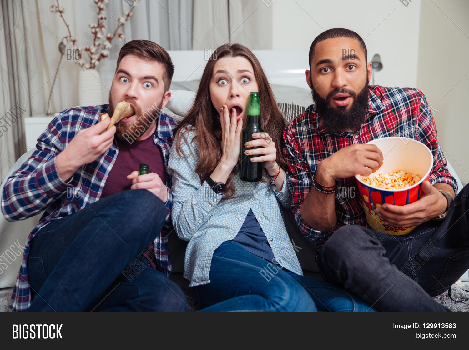 multiracial group of frightened shocked young people drinking