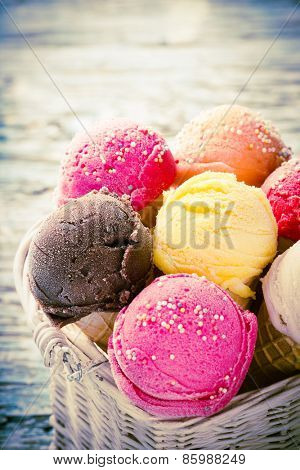 ice cream scoops on wooden table, close-up.
