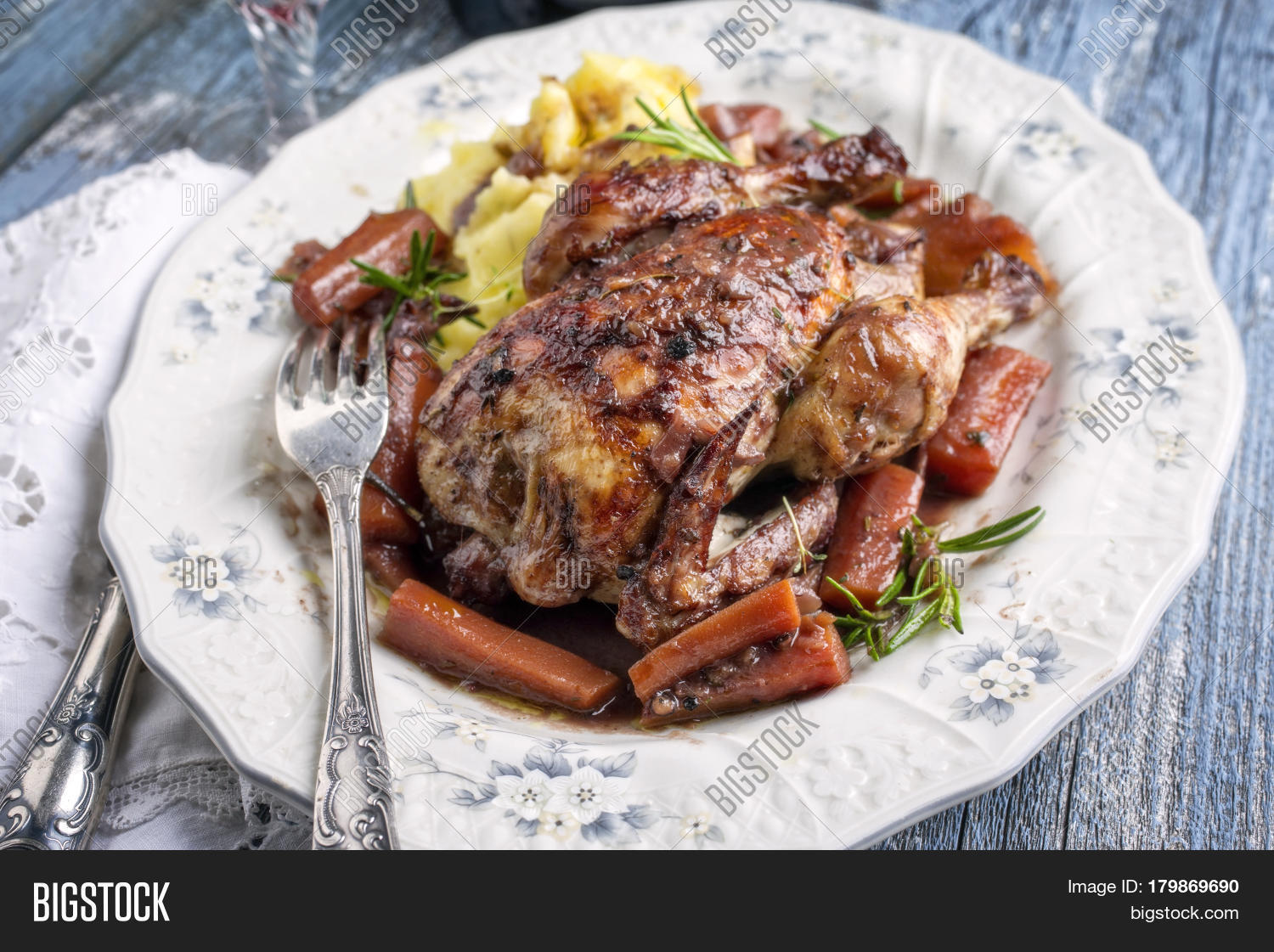 coq au vin with vegetable and potato puree in burgundy sauce as