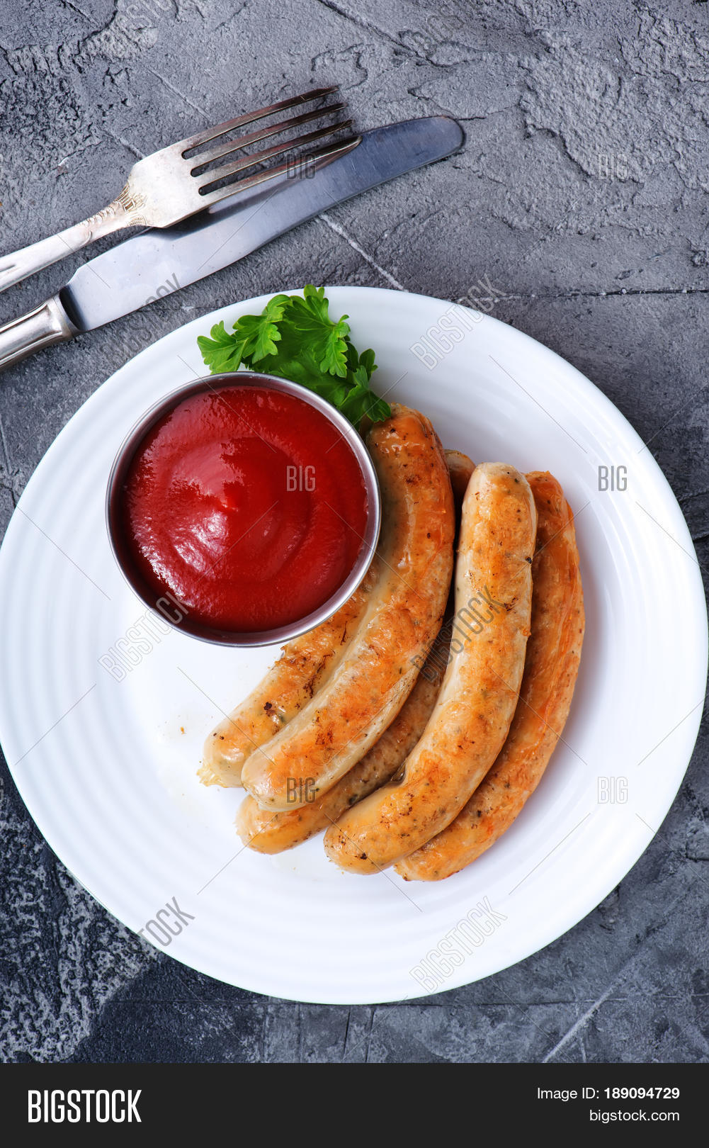 sausages with sauce on plate stock photo