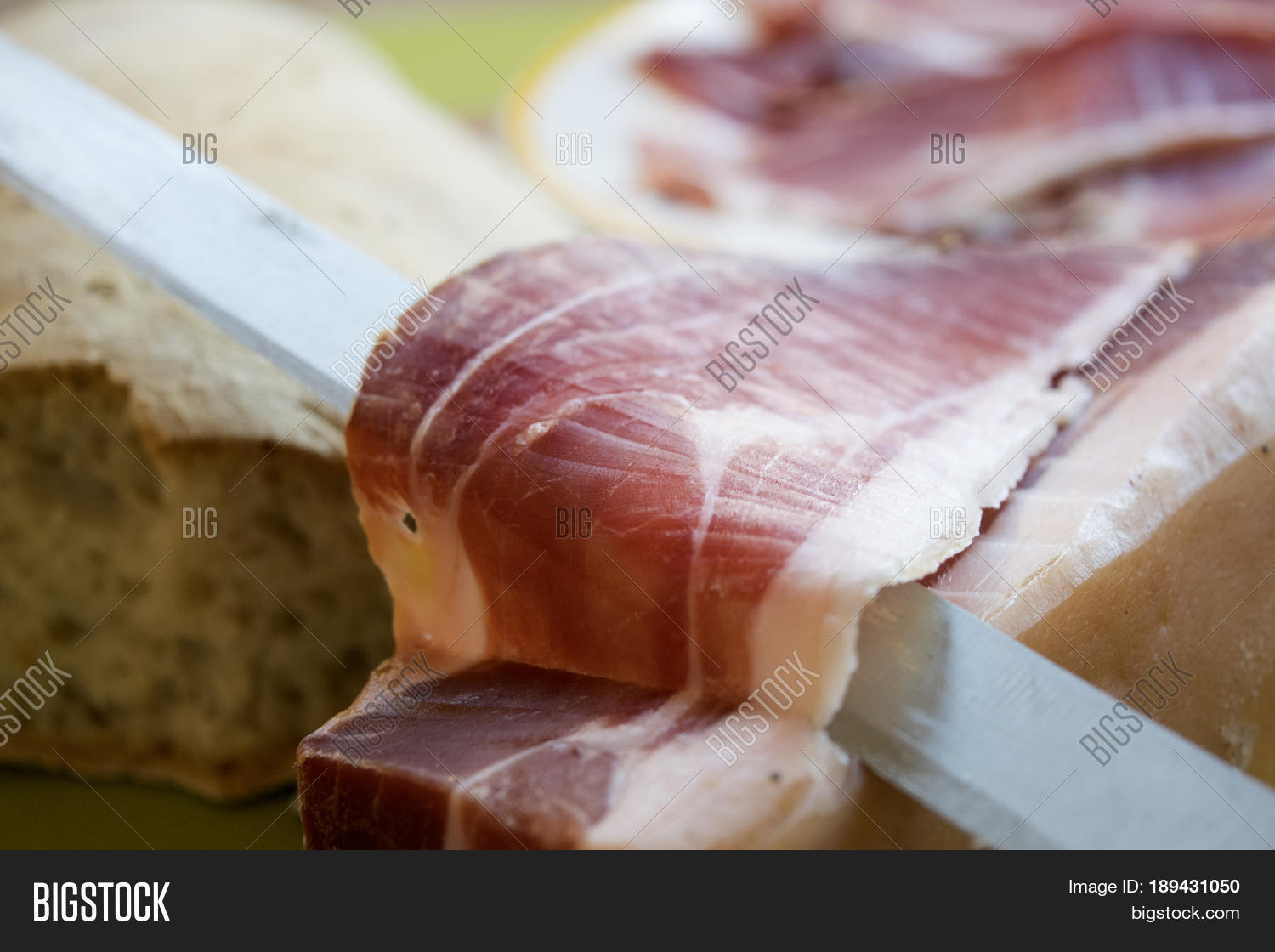 famous italian dry-cured ham called prosciutto di parma cut by