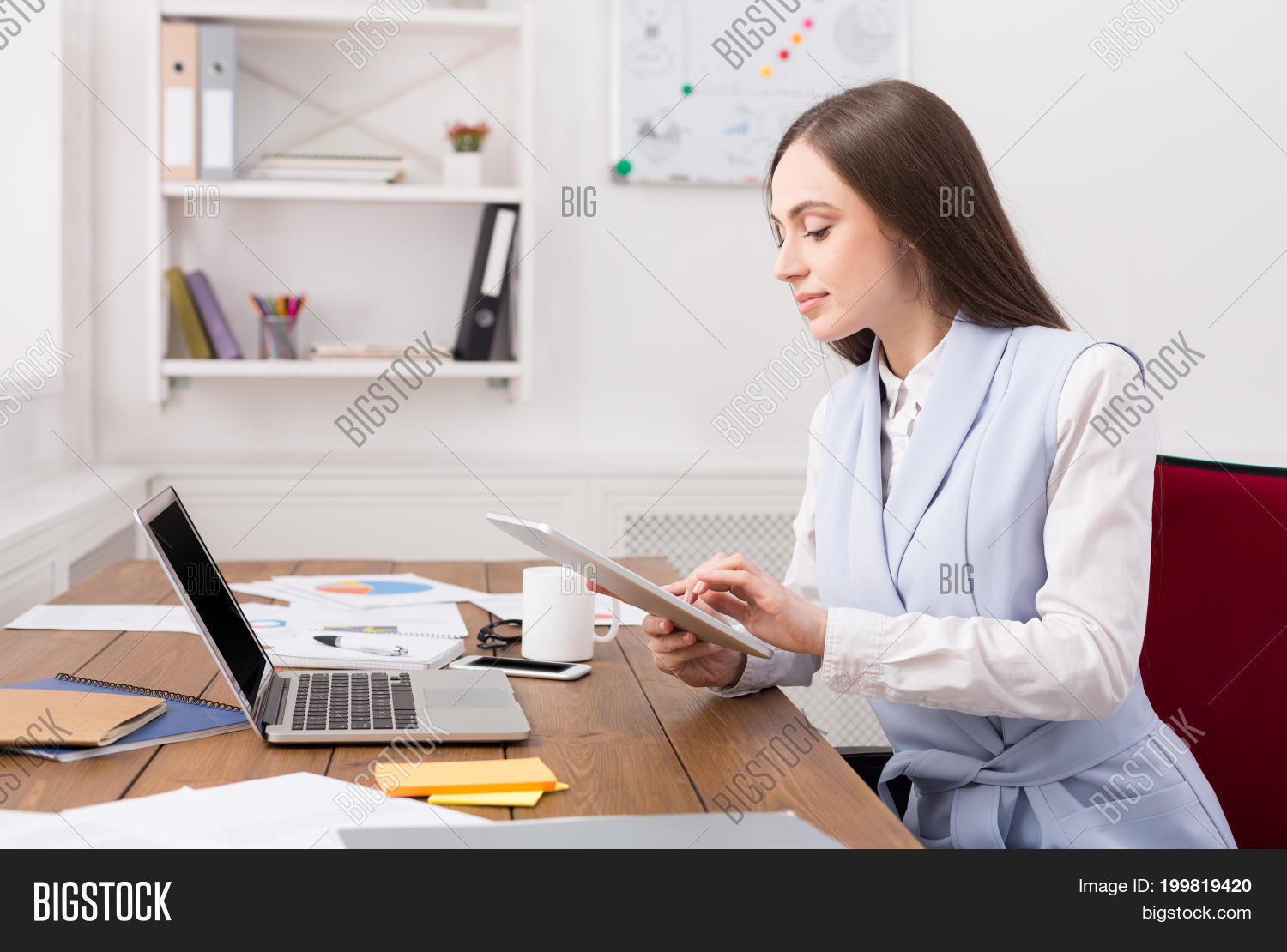 confident young business woman in formalwear working on digital